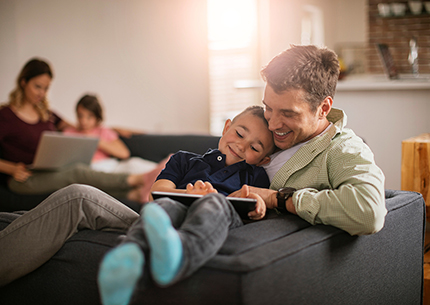 dad and son looking at tablet